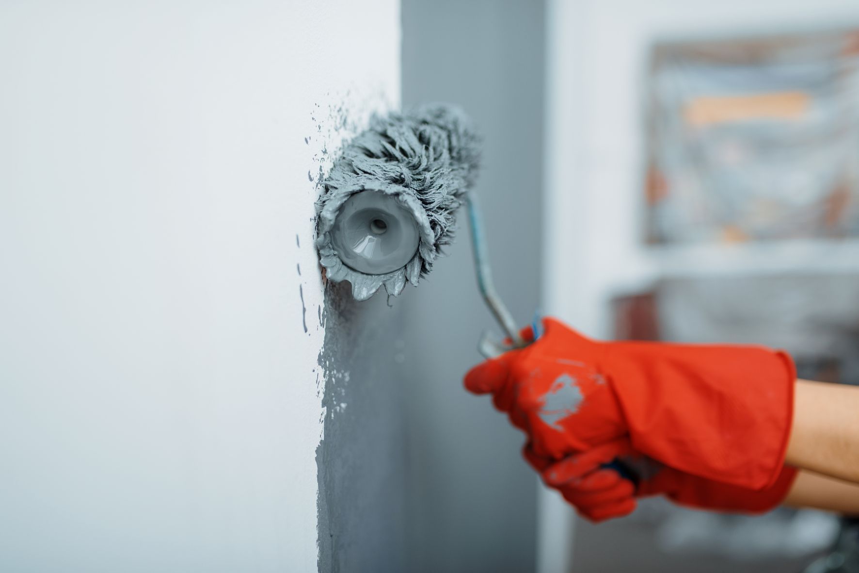 applying paint on the walls with a roller