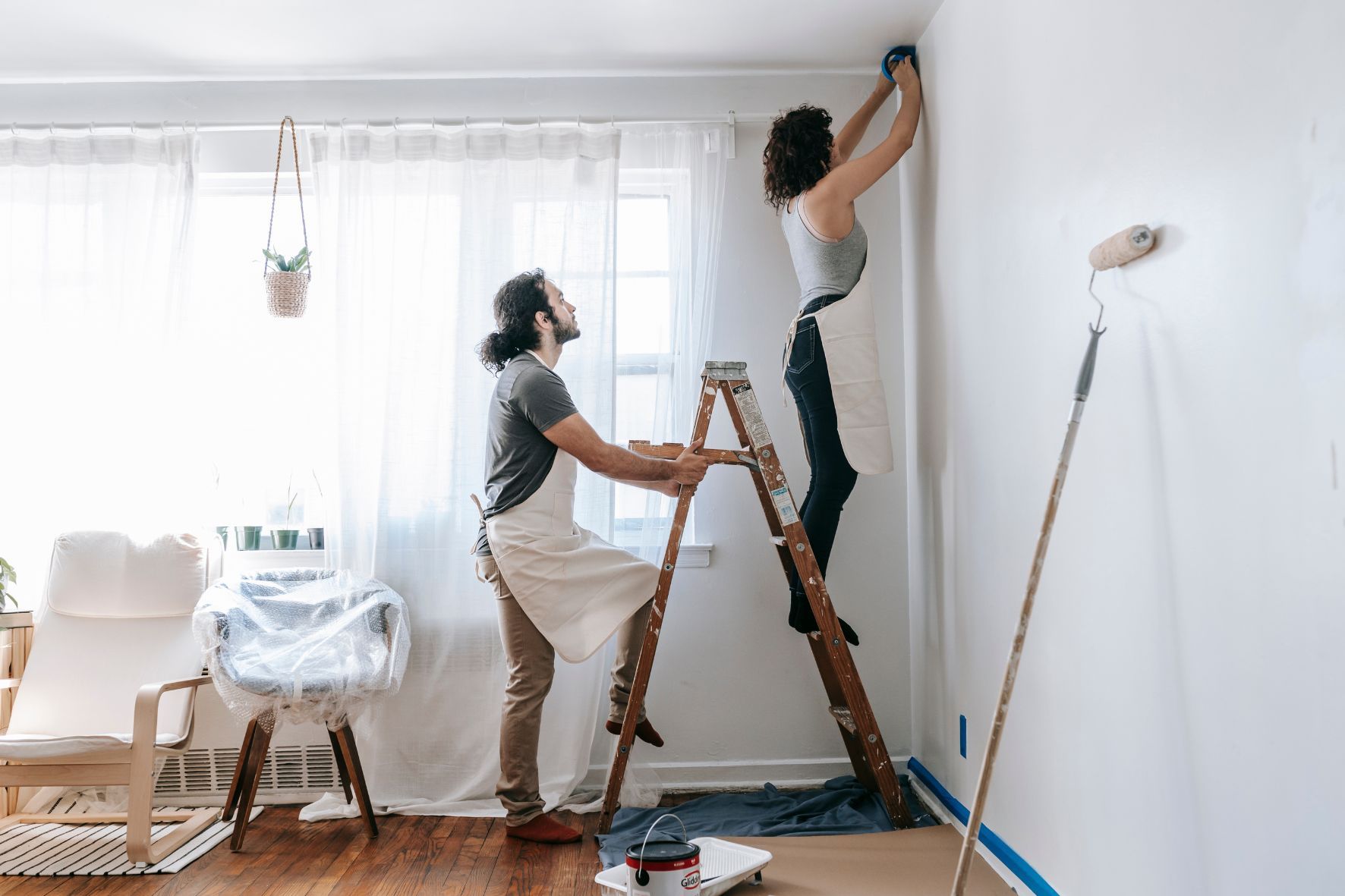 couple preparing walls for painting