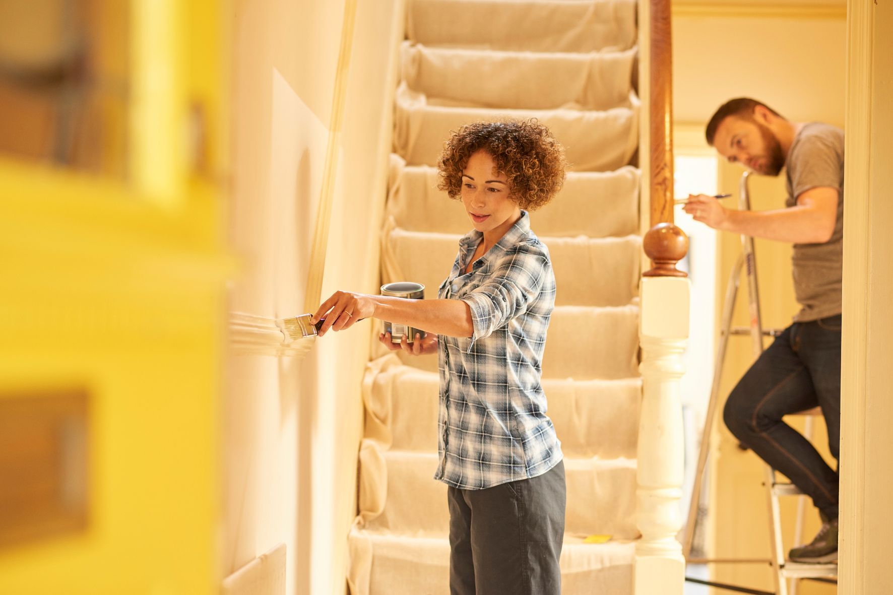 Couple painting a hallway