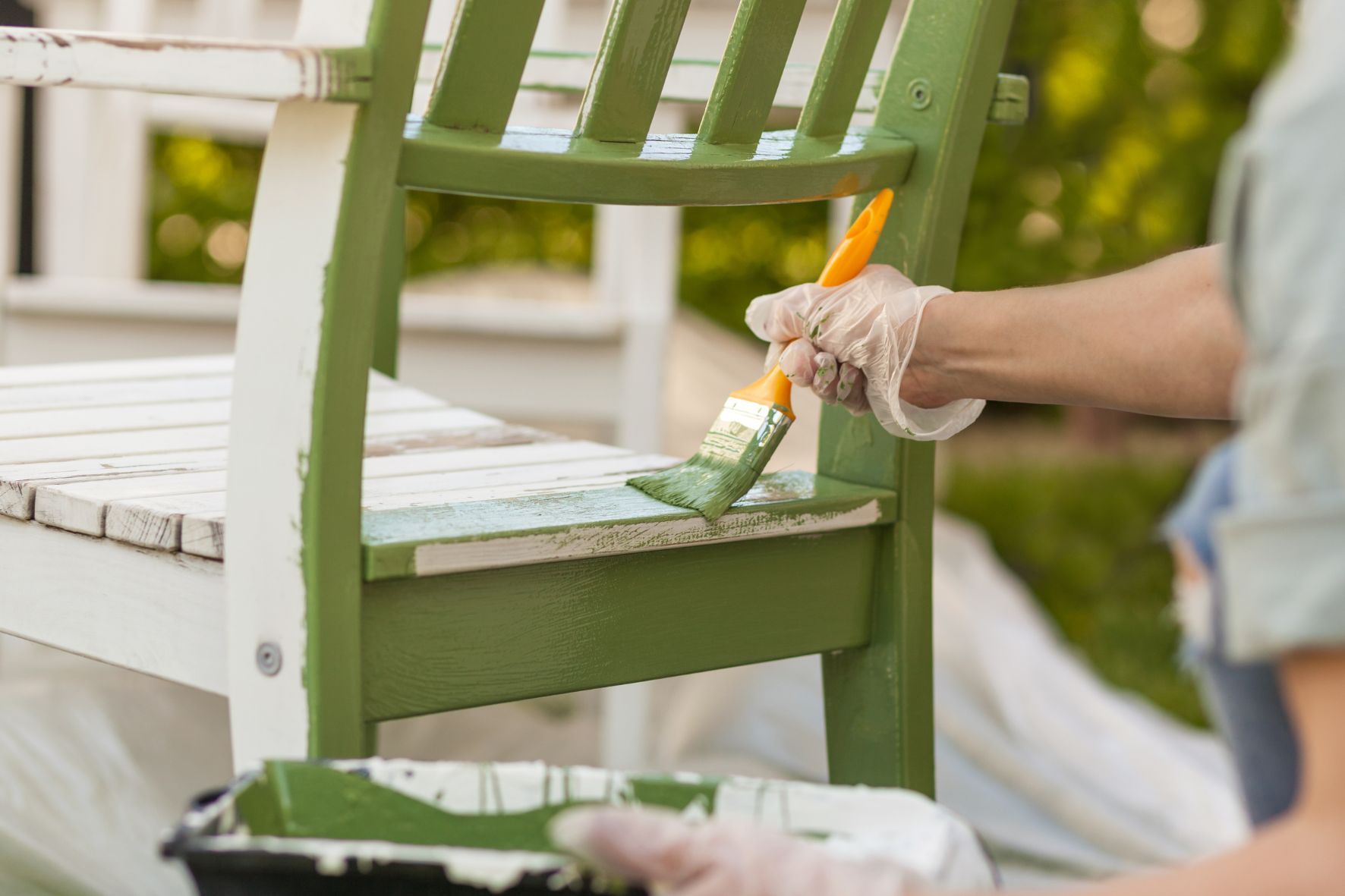 Person painting a chair