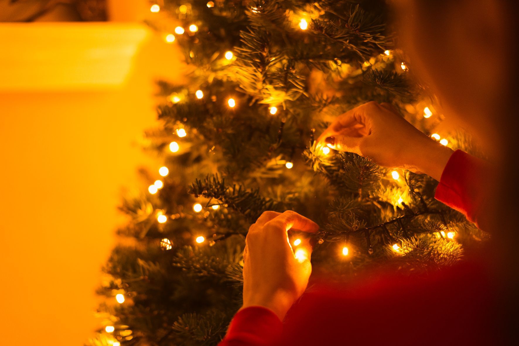 Person hanging up christmas lights