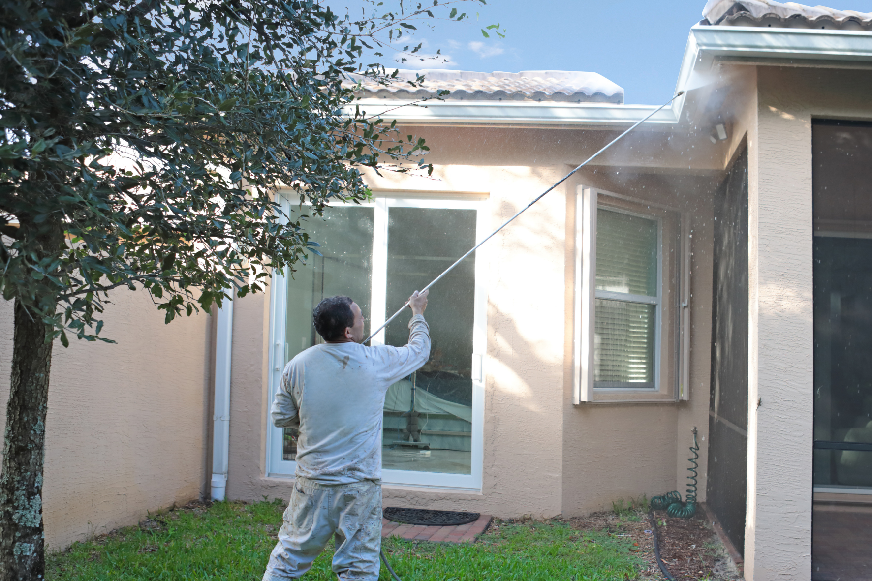 Tru colors team pressure washing the exterior of florida home