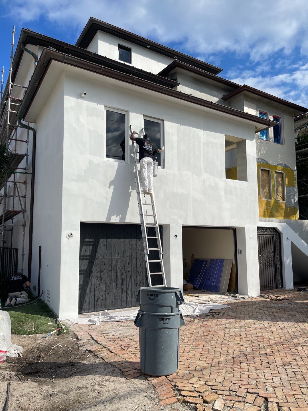 Man painting exterior of a house in florida