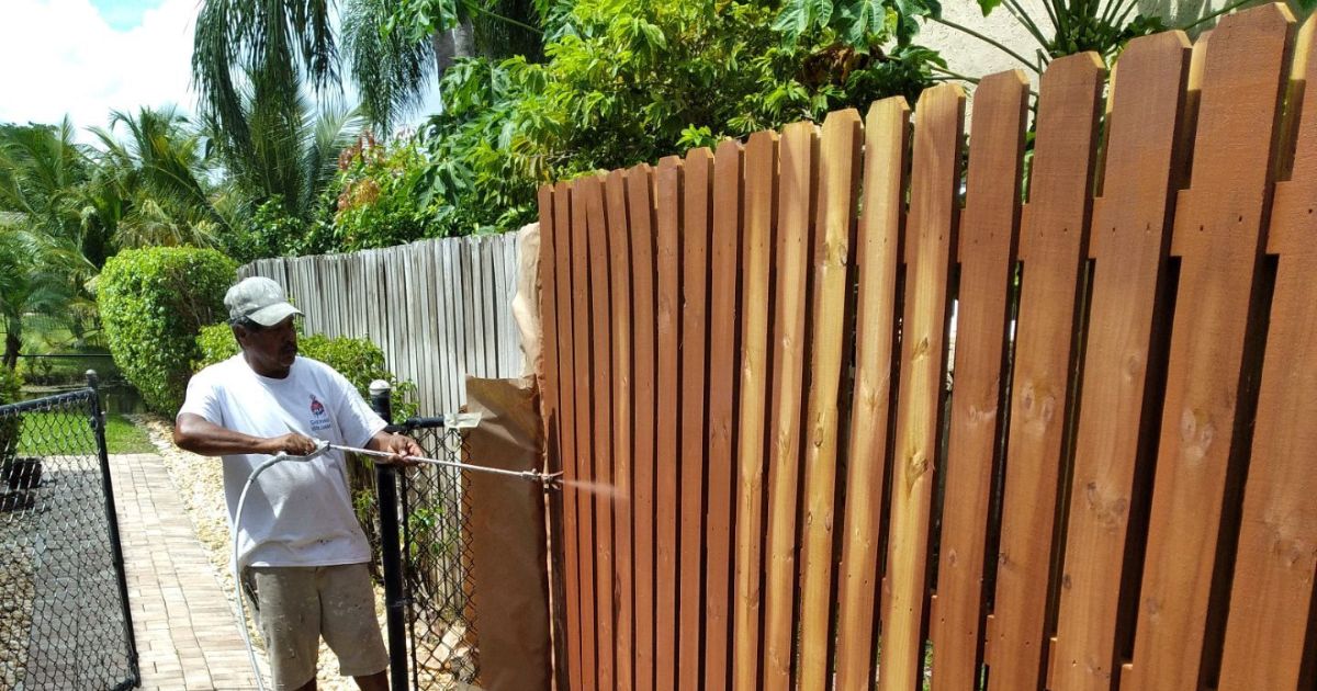 Tru Colors contracting painting a fence